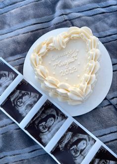 a heart shaped cake sitting on top of a white plate next to three pictures and an album