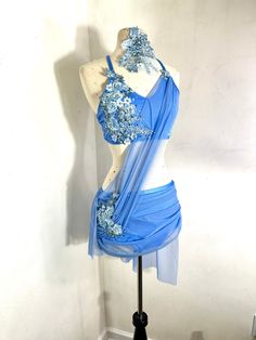 a mannequin dressed in blue with flowers on it