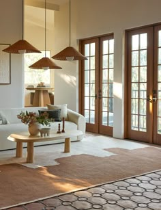 a living room filled with furniture and lots of windows