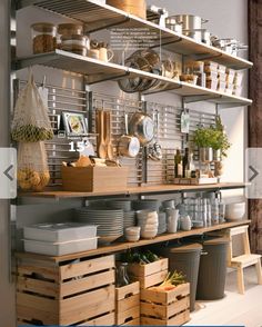 the shelves are filled with pots, pans and other kitchen utensil items