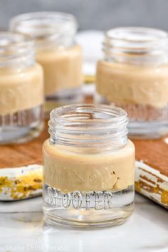 jars filled with peanut butter sitting on top of a table