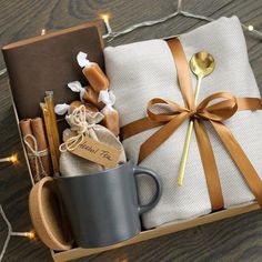 a gift box filled with coffee, marshmallows, and other items for someone's special occasion