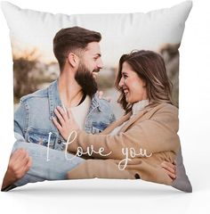 a pillow with the words i love you printed on it and two people hugging each other