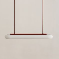 a white light hanging from a ceiling fixture