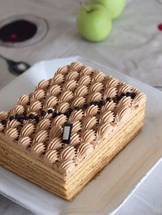 a piece of cake sitting on top of a plate next to an apple and knife