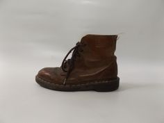 vintage 90s brown leather combat boots  - size 4 UK -- US size 6 - brown leather  - 6 hole lace up combat boot  - unisex grunge rocker shoes  - 1990s docs  - hippie boho shoe LABEL - made in england MATERIAL -- leather and man made soles CONDITION -- good vintage with wear -- back tab on one boot is missing, scuff marks/nicks/spots from normal wear MEASUREMENTS IN INCHES size -- 4 on boots  insole length - taken inside boot --  8.75   outside of boot -- 9  width of foot --  3.75  heel height -- Vintage Brown Ankle-high Martin Boots, Brown Lace-up Vintage Martin Boots, Vintage Brown Lace-up Martin Boots, Brown Vintage Lace-up Martin Boots, Vintage Brown Martin Ankle Boots, Grunge Leather Martin Boots With Round Toe, Vintage Brown Combat Boots For Winter, Vintage Brown Combat Boots With Round Toe, Vintage Brown High-top Martin Boots