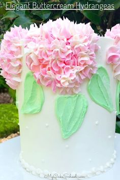 a white cake with pink and green flowers on it