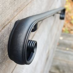 a black door handle on the side of a building