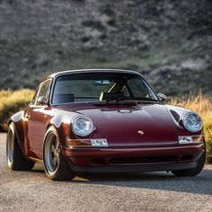 a red sports car is parked on the side of the road