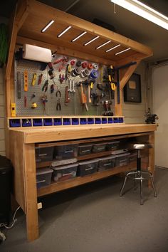 a workbench with lots of tools hanging on the wall