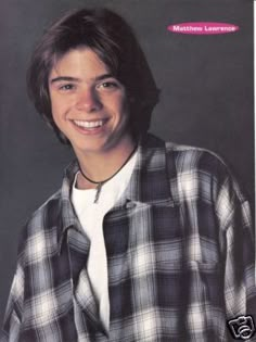 a young man is smiling for the camera