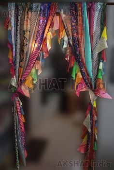 colorful ribbons hanging from the ceiling in front of a doorway