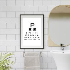 an eye chart print hangs on the wall next to a sink