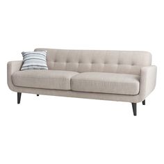 a white couch with two pillows on it's back and the seat upholstered