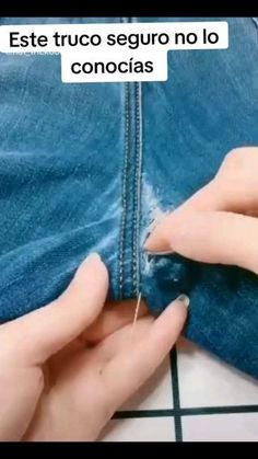 someone is sewing something on their jeans