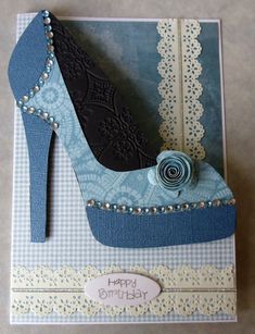 a birthday card with a high heel shoe on the front and a blue ribbon around the bottom