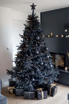 a black christmas tree with presents under it