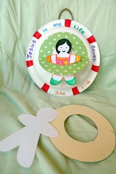 a paper plate with a girl on it next to a cutout of an o