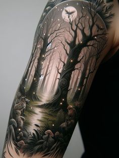 a woman's arm with a forest scene on it