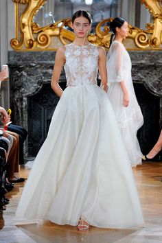 a model walks the runway in a white wedding dress