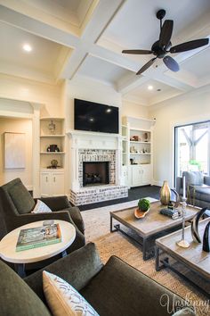 a living room filled with furniture and a flat screen tv mounted on the wall above a fireplace