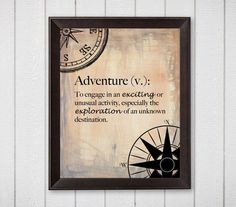 a framed poster with an old fashioned compass on it's side, and the words adventure written in cursive writing