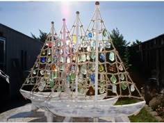 a boat made out of glass bottles sitting on top of a rock