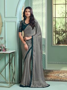 Introducing the "Moonlit Grace Grey Georgette Saree," available for rent, a masterpiece that epitomizes understated elegance and refined sophistication. Crafted from premium georgette fabric in a soft grey hue, this saree exudes a timeless allure, perfect for any special occasion where you wish to exude grace and charm. The subtle grey color offers a versatile and sophisticated look, ideal for weddings, festive celebrations, or formal gatherings. The lightweight and flowing georgette fabric ensure a flawless drape, providing both comfort and effortless style as you move gracefully throughout the event. Adorned with delicate embellishments and intricate detailing, the "Moonlit Grace" saree showcases exquisite craftsmanship. Its understated elegance is enhanced by the subtle sheen of the geo Saree Ready To Wear, Georgette Silk Saree, Grey Saree, Indian Party Wear, Saree For Women, Ready To Wear Saree, Party Wear Lehenga, Bridal Lehenga Choli, Elegant Saree