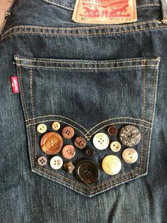 a pair of jeans with buttons in the back pocket