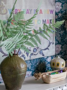 there is a plant in a vase on the table next to other decorations and toys