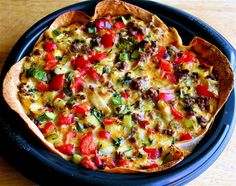 a pizza sitting on top of a pan covered in toppings