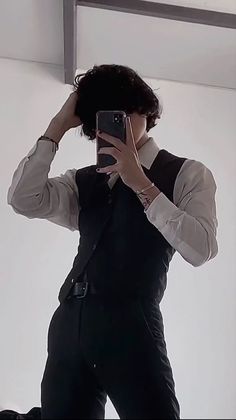 a man taking a selfie in front of a mirror with his cell phone up to his ear