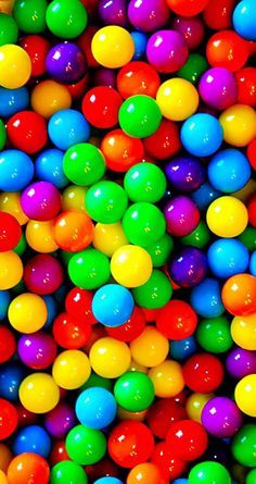 there are many different colored balls in the photo