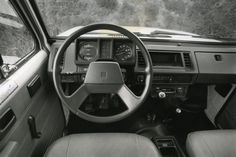 the interior of a truck with dashboard and steering wheel