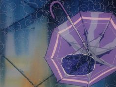 an umbrella painted on the side of a building with blue and purple designs around it