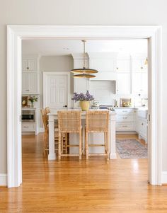 an open door leading to a kitchen and dining room