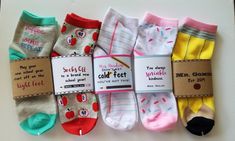 five pairs of socks with different sayings on them, one for each child's feet