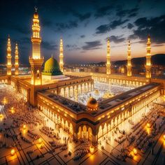 an aerial view of the grand mosque at night, with lights on and around it