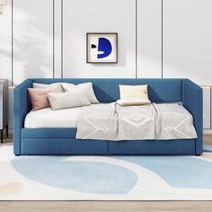 a blue couch sitting on top of a white rug