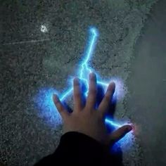 a person's hand is shown glowing blue