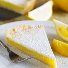 a slice of lemon cake on a plate with a fork