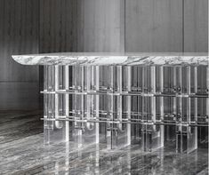 a marble and glass console table in the middle of a room