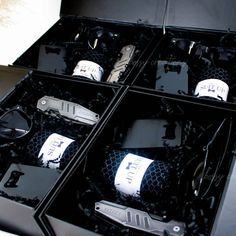 an open black box containing several different types of knives and knives with tags on them