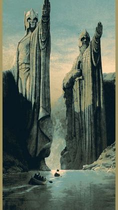 two large statues standing next to each other in front of a body of water and mountains