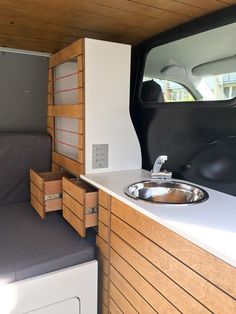 the interior of a camper with a sink and washbasin in front of it