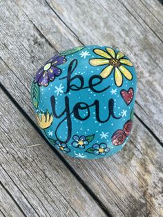 a painted rock with the words be you on it