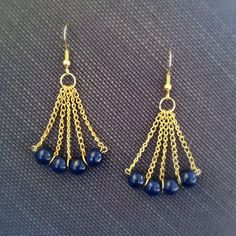 two pairs of blue beads are hanging from gold - plated chain earwires