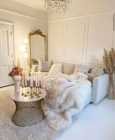 a living room filled with furniture and a chandelier