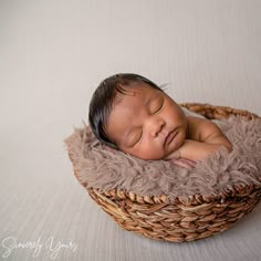 a newborn baby is sleeping in a basket