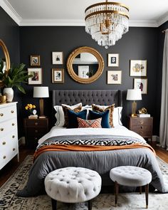 a bedroom decorated in black, white and gold with a large round mirror above the bed